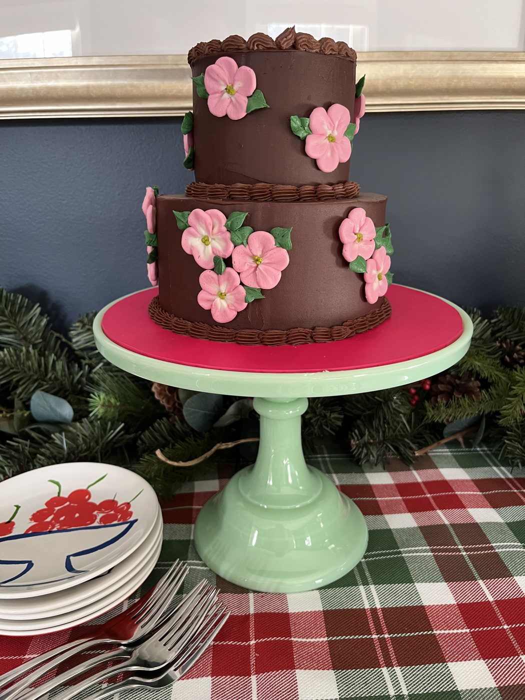 Two-tier chocolate cake with pink sugar flowers